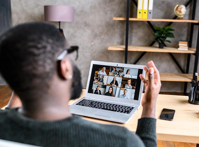 Man sitting on his computer in a virtual meeting